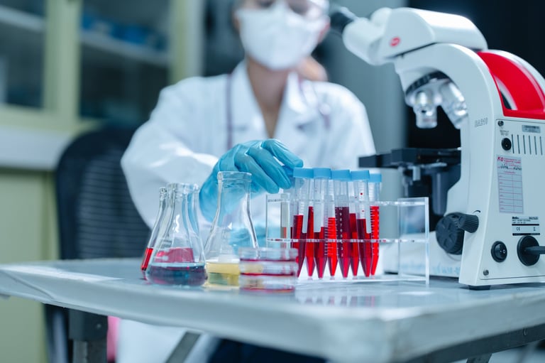 Blood samples in a test tube rack with a laboratory scientist and microscope, representing the specimen and lab materials MedGo transports